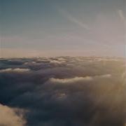 A Light Peaking Through The Clouds Behind Clouds